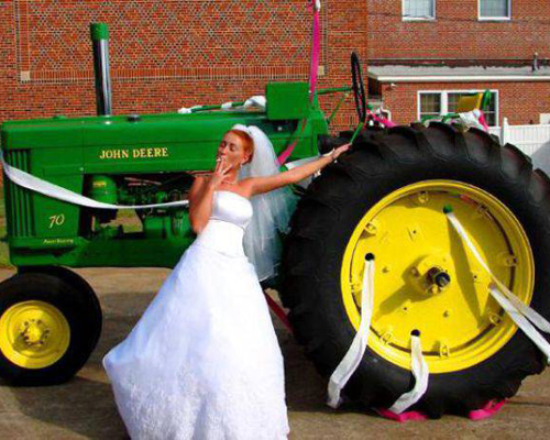 At least she brought the good tractor. Wedding Tractor, Bride and tractor Funny Wedding Pictures, Bad Wedding Photos,Wedding disasters, disastrous weddings, ugly wedding dresses, bad wedding dresses, wedding photography, wedding photographers, horrible weddings, wedding invitations, affordable weddings, worst wedding pictures