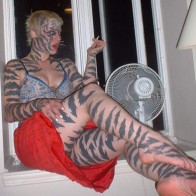 Cat woman Tattoos woman who looks like a cat tattoos worst tattoos ugliest tattoos wtf horrible tattoos awkward family photos bad family photos horrible p tattoo pics funny pictures fail