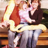 Family portrait with snake boa Family Portraits Bad Family Photos Ellen worst family pics funny pictures awkward family photos wtf ugly people stupid people crazy people weird people
