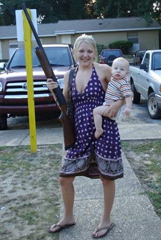 mom holding baby and shotgun posing for camera ~ Worst Parents Ever