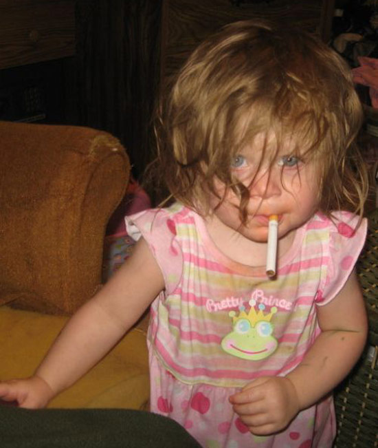 disheveled baby girl with cigarette dangling from mouth ~ Worst Parents Ever