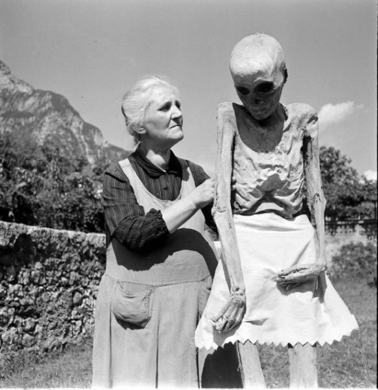 woman holding mummy scarecrow