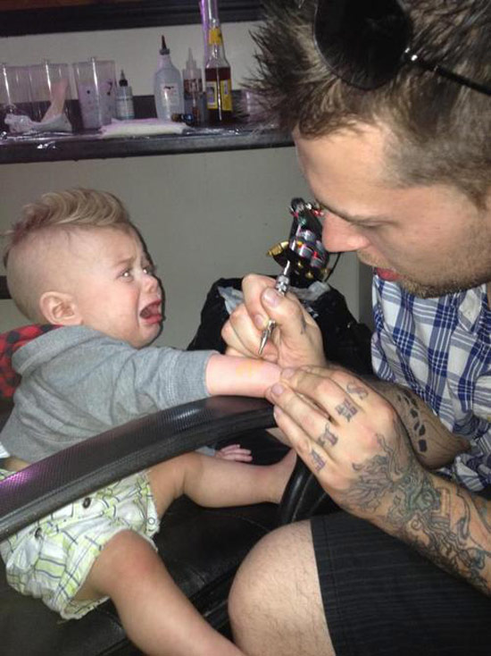 dad tattooing screaming baby ~ Worst Parents Ever
